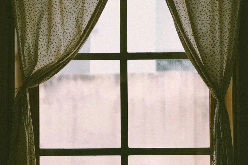 Sheer curtains beside a window with soft diffused daylight